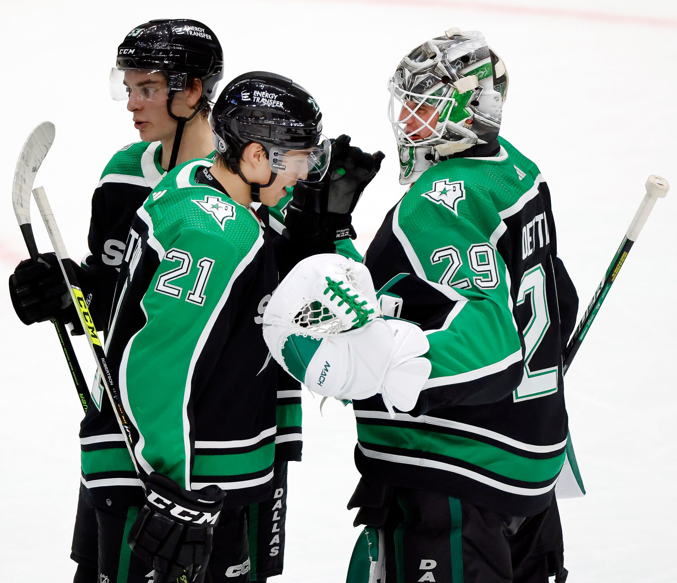 Dallas Stars left wing Jason Robertson (21) and goaltender Jake Oettinger (29) congratulate...