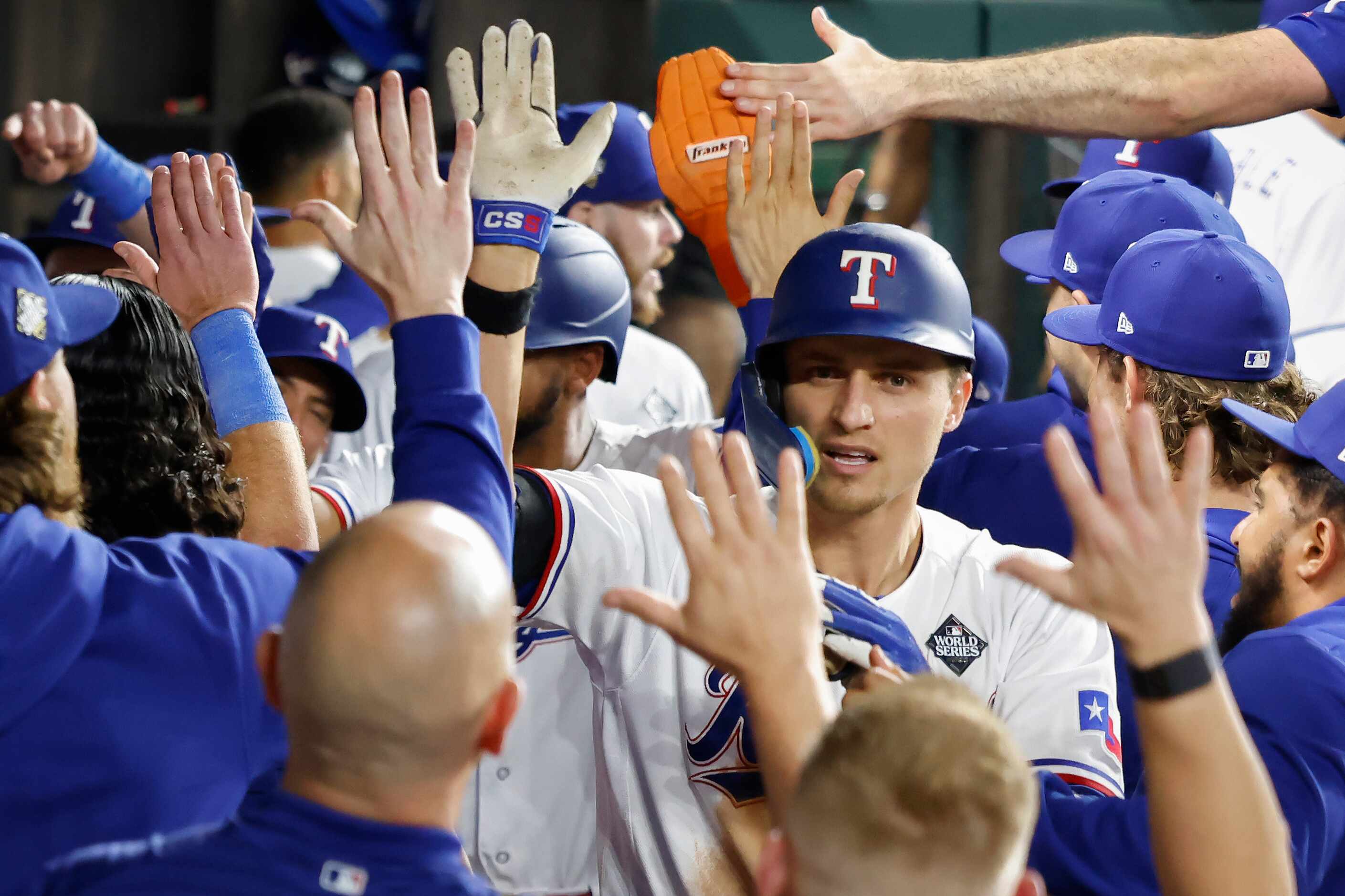 Texas Rangers' Corey Seager is congratulated in the dugout after hitting a two-run home run...