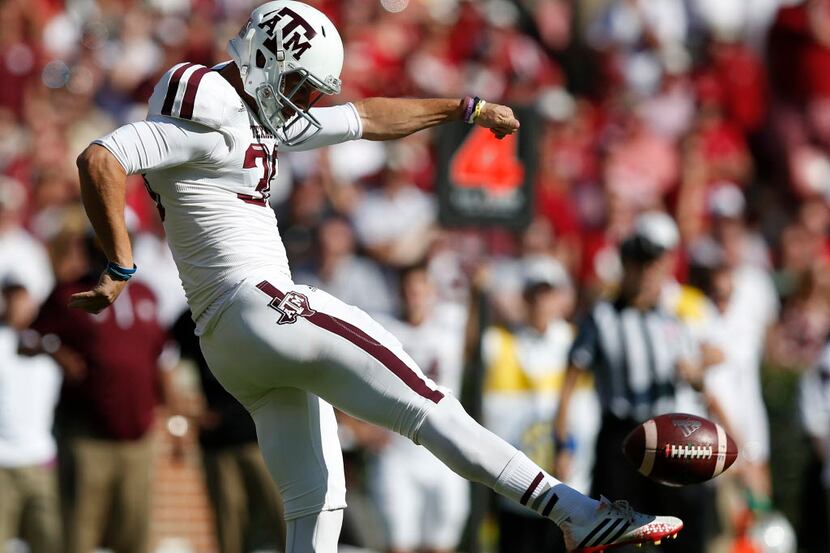 Texas A&M punter Drew Kaser (38) punts the ball against Alabama during the first half of an...