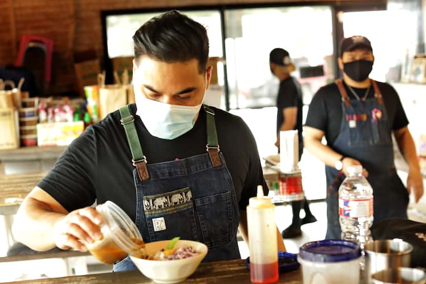 Donny Sirisavath, left, prepares khao poon at Khao Noodle Shop in Dallas in June 2020. A...