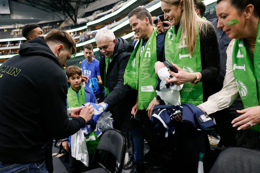 Dallas Mavericks guard Luka Doncic signs autographs for Slovenian fans after an NBA game,...