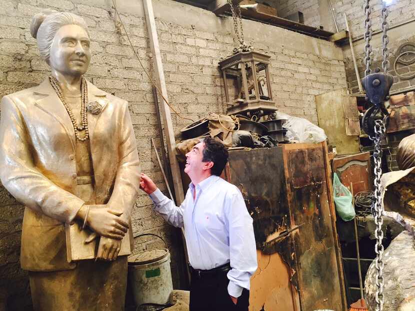 Sculptor Germán Michel inspects his work, a statue of the late civil rights leader and...
