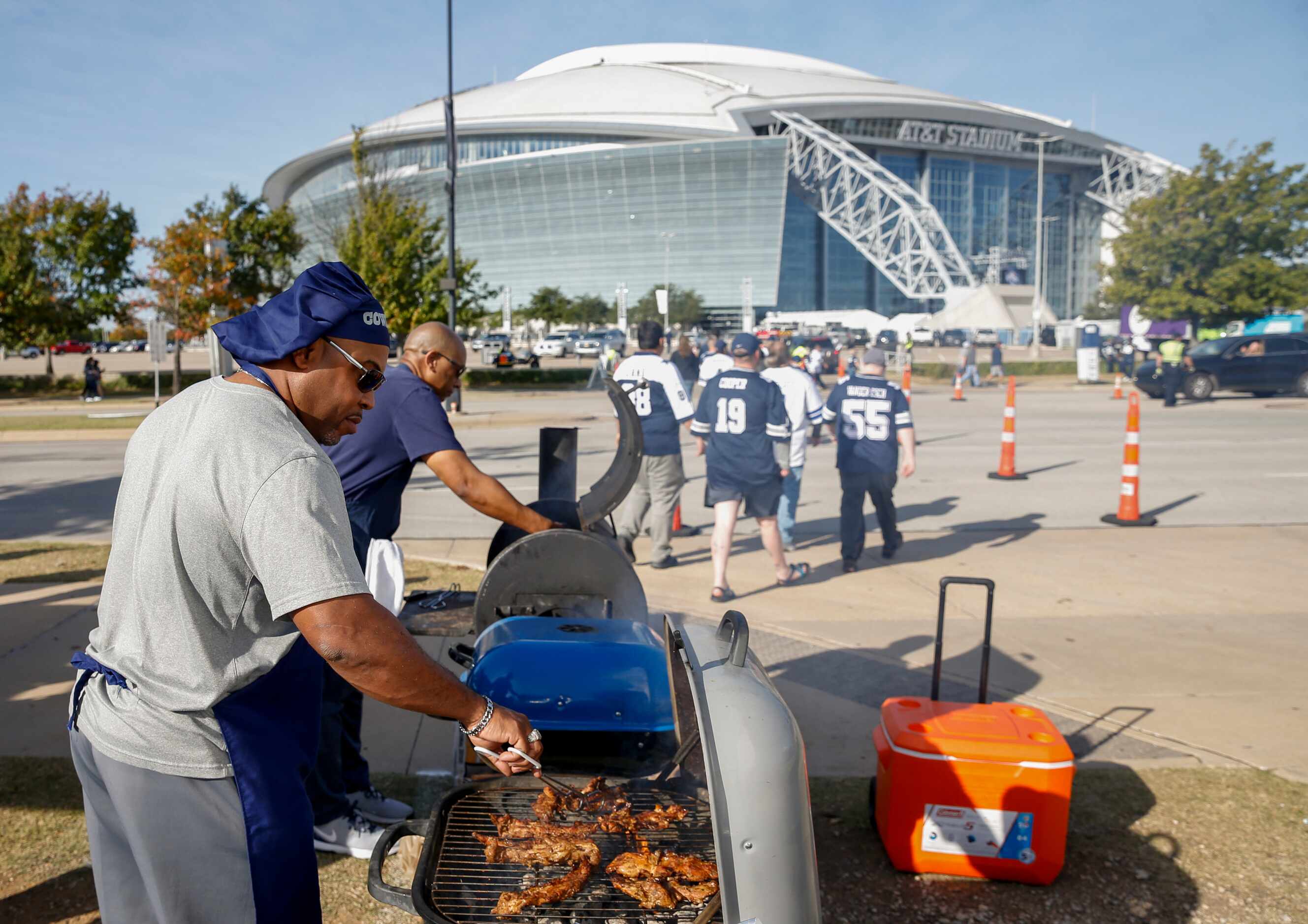 Ferdinand Shaw, 53, tends to the grill before an NFL football game between the Dallas...