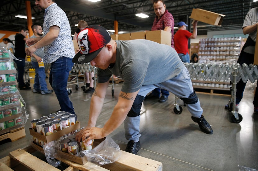 Fredy Maldonado of Dallas works on putting together boxes for distribution at North Texas...