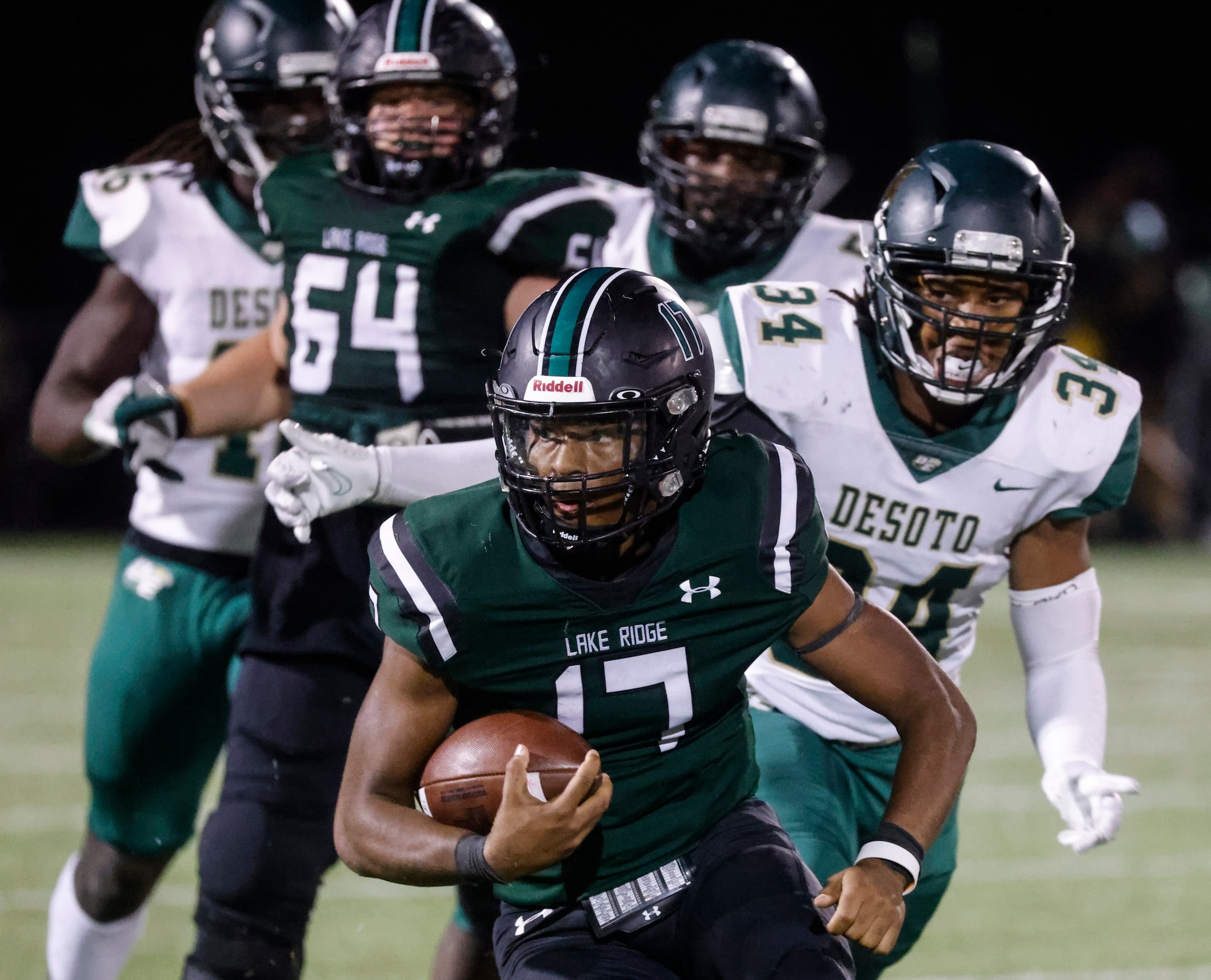 Lake Ridge High’s Kennen Miller (17) runs for a yardage against DeSoto High during the...