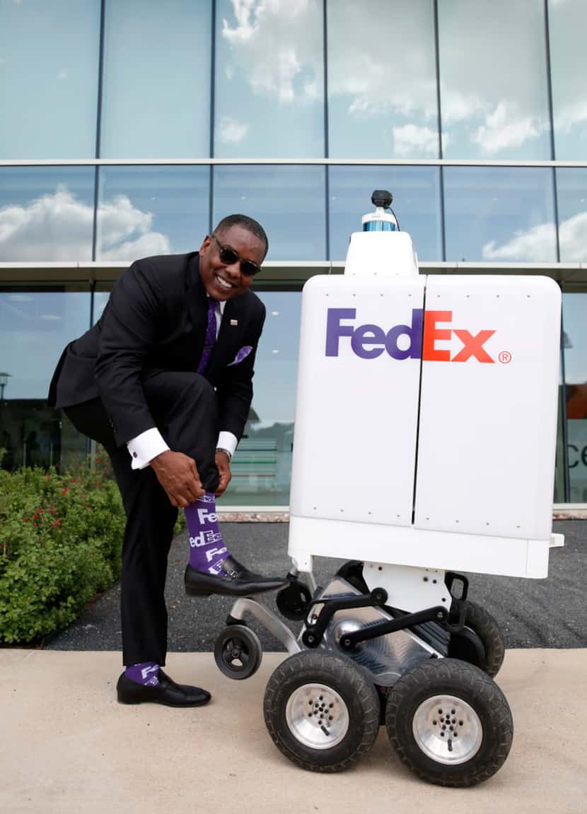 Mayor of Plano Harry LaRosiliere shows off his FedEx socks during a demonstration for the...