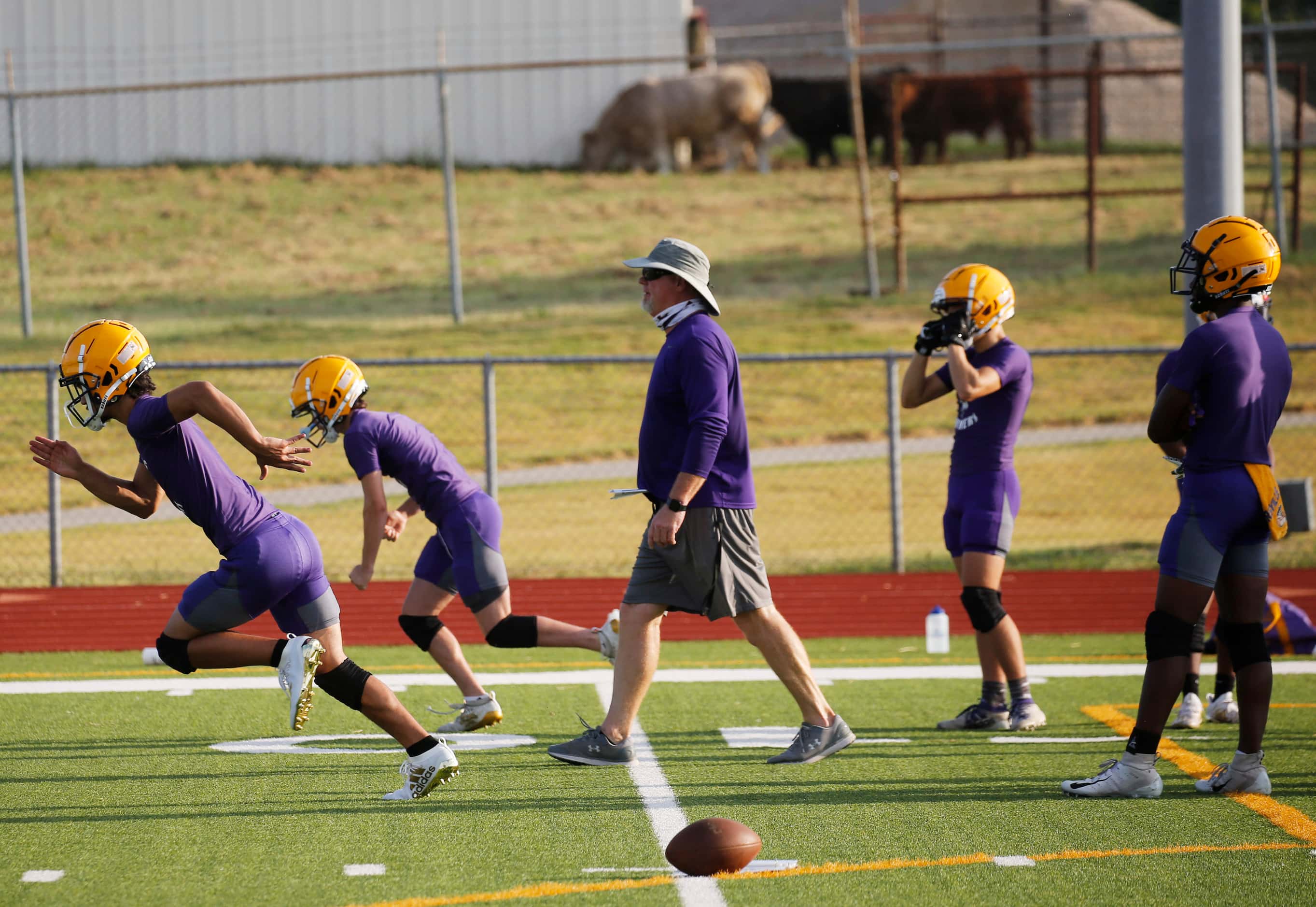 Players run through a drill during the first day of high school football practice for 4A's...