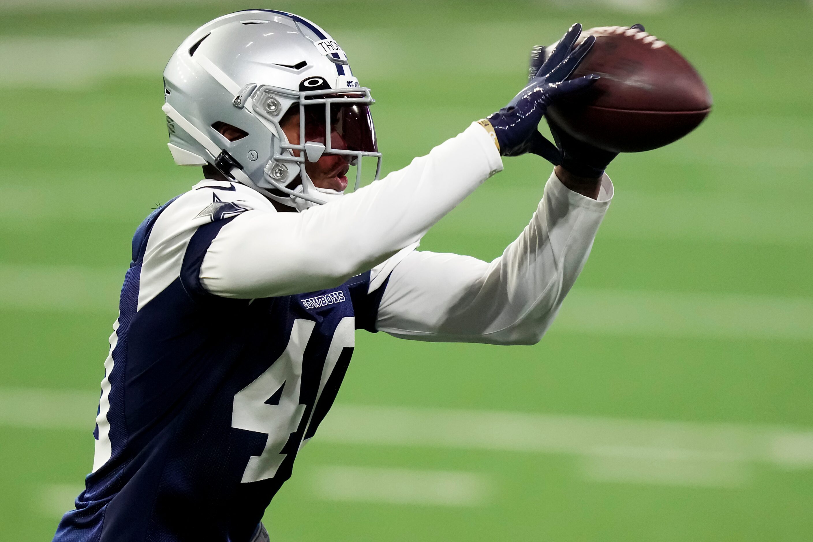 Dallas Cowboys safety Juanyeh Thomas (40) catches a ball during the OTA team's practice at...