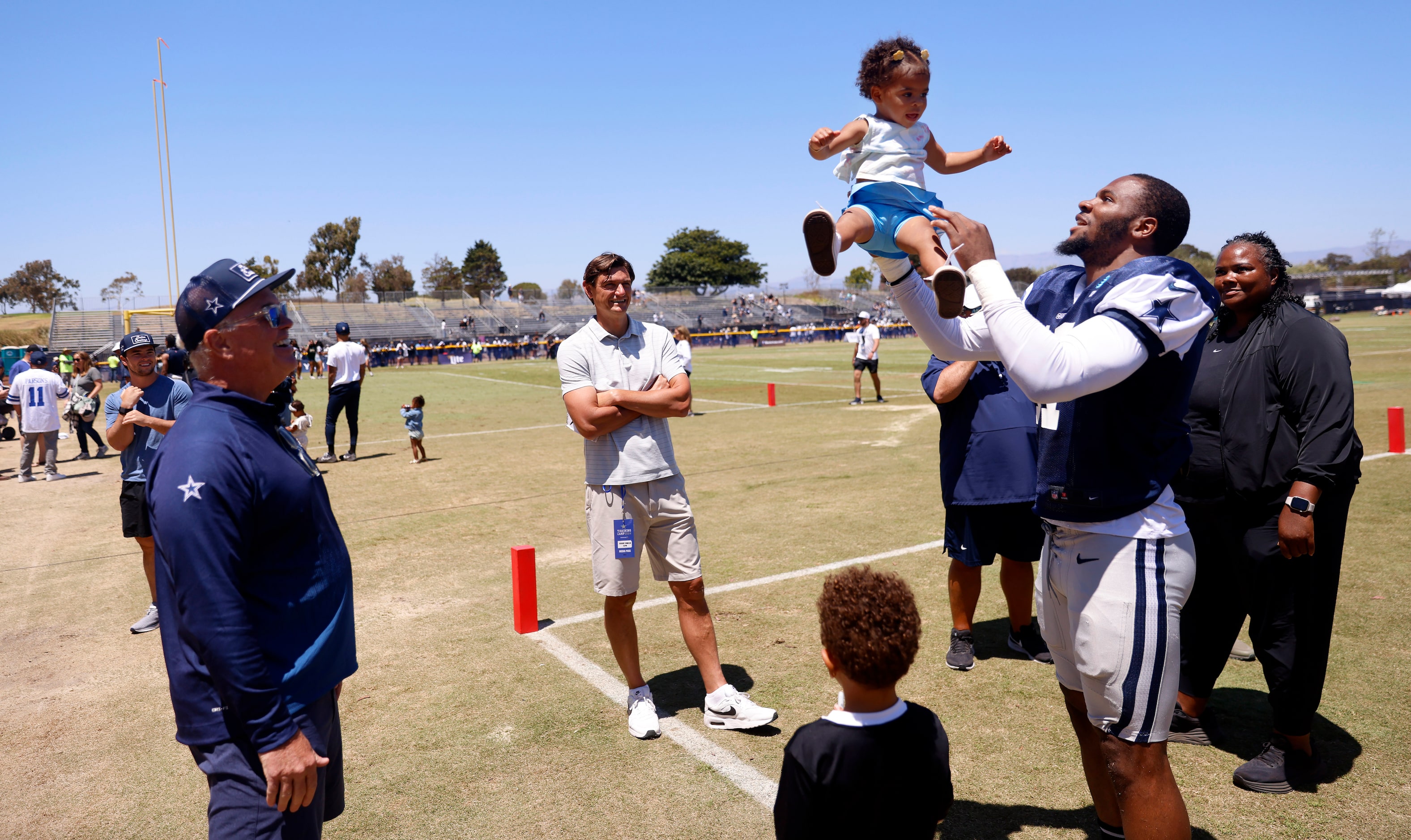 Dallas Cowboys linebacker Micah Parsons (right) tosses his daughter Milana as Dallas Cowboys...