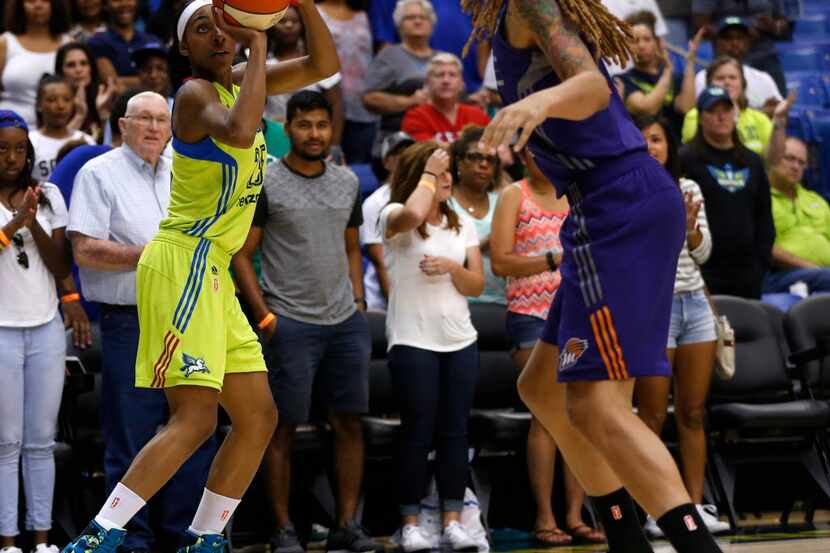 Dallas Wings forward Glory Johnson (25) takes a shot against Phoenix Mercury center Brittney...