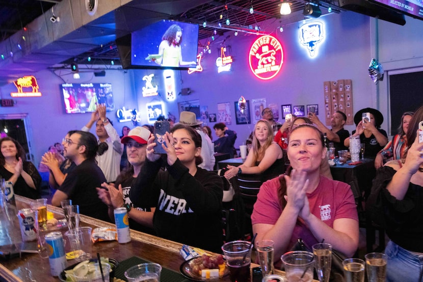 Panther City BBQ bartenders Melissa Vargas (second to right) and Bre Ross (right) clap as...