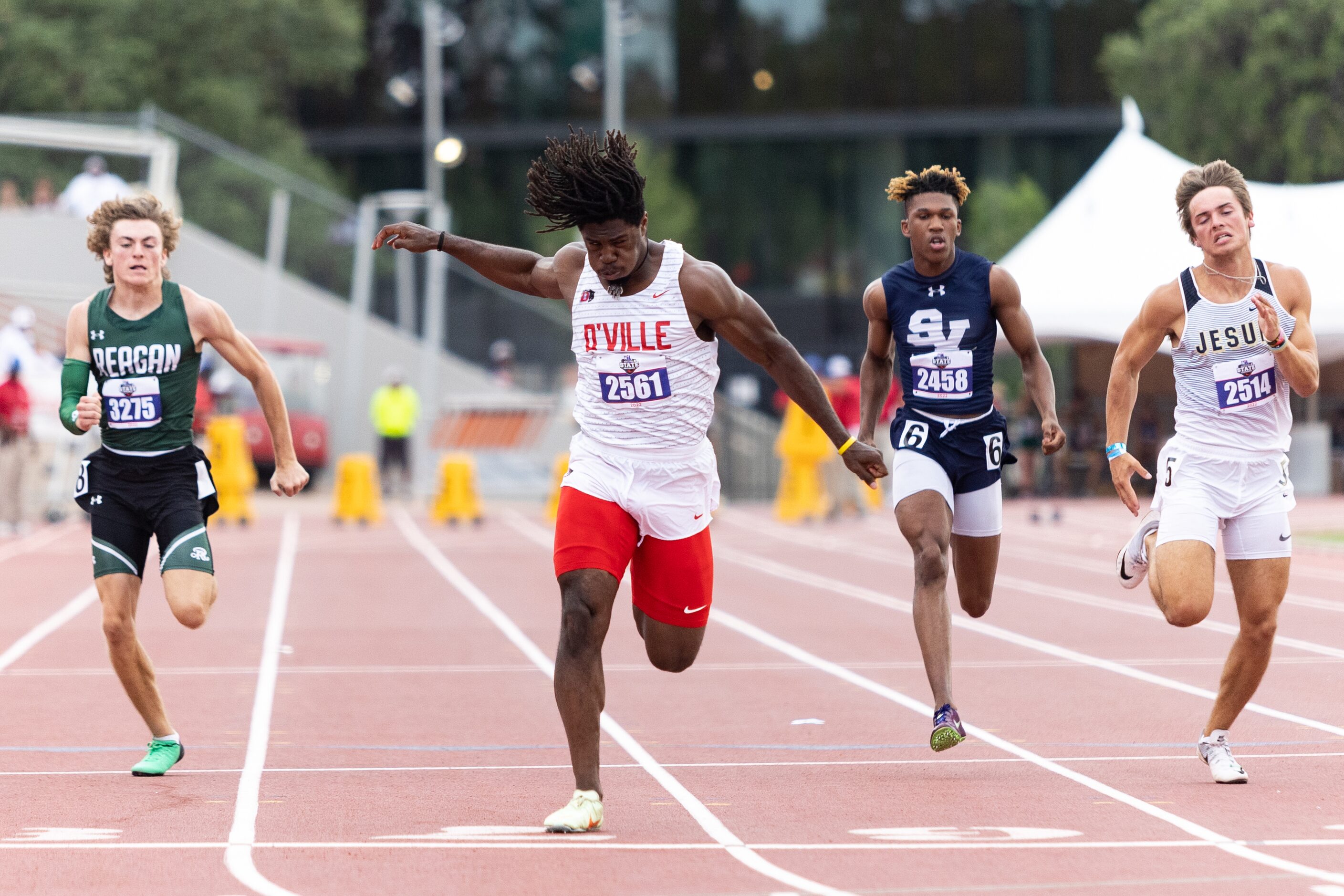 Pierre Goree of Duncanville, center, sprints to the finish line at the UIL Track & Field...