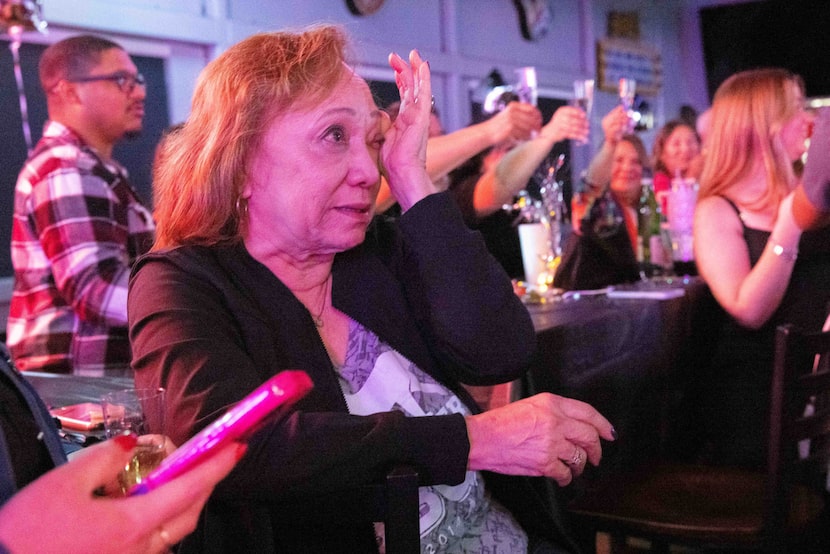 Deanna Menchaca, mother of Panther City BBQ co-owner Ernest Morales, wipes away tears after...