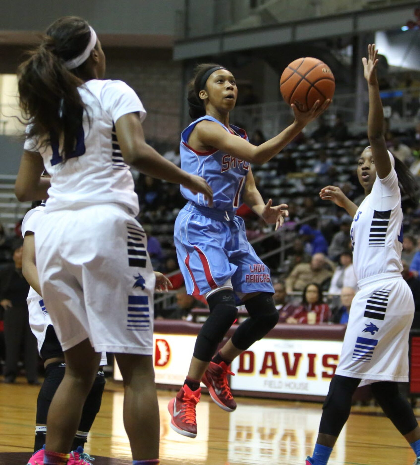 Skyline guard Christalah Lyons (center) drives to the hoop during first half of the region...