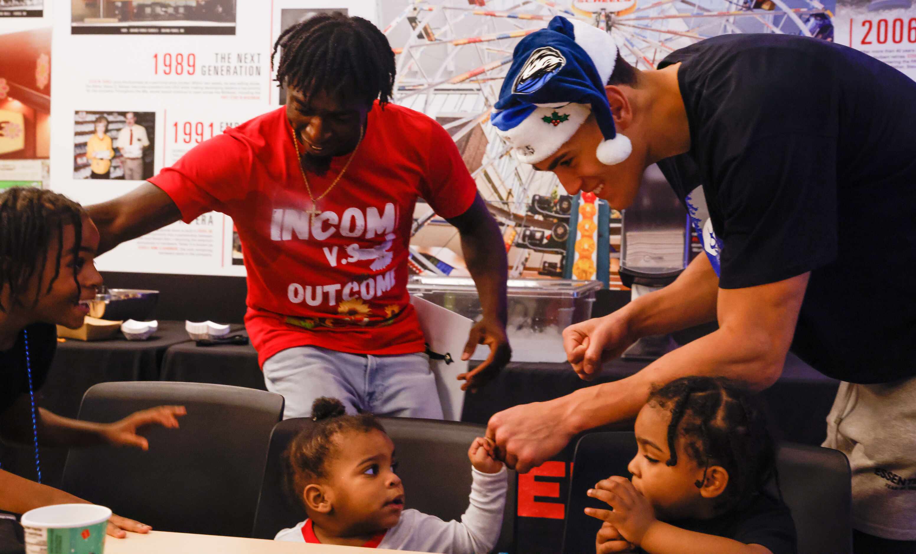 The Givens family meets Dallas Mavericks center Dwight Powell (right) before shopping with...