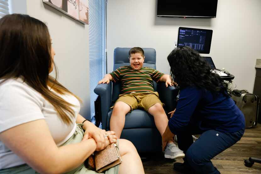Connor Cagle, 8, at an exam room with his mother, Kathryn Cagle, 32, and pediatric...