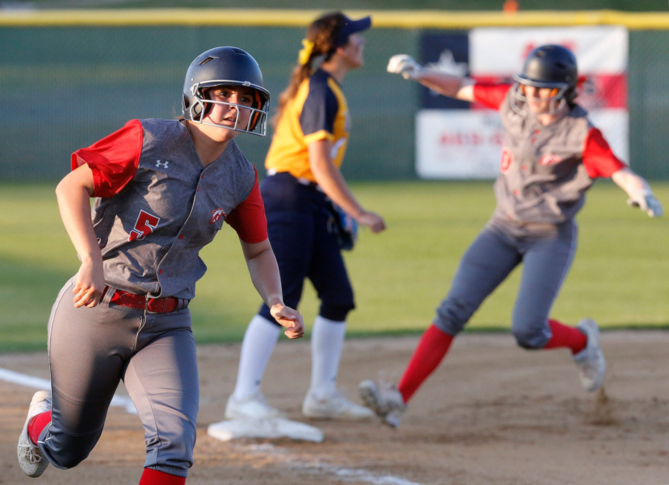 McKinney Boyd High School first baseman Anissa Lechner (5) rounds third on her way to...