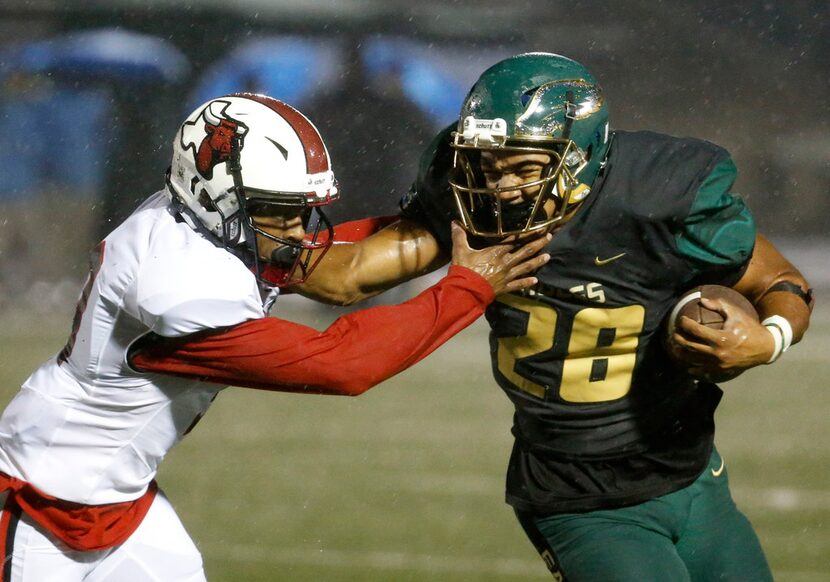 DeSoto's Roston White runs ahead of Cedar Hill's Kirk Lockhart (9) in the first half of...