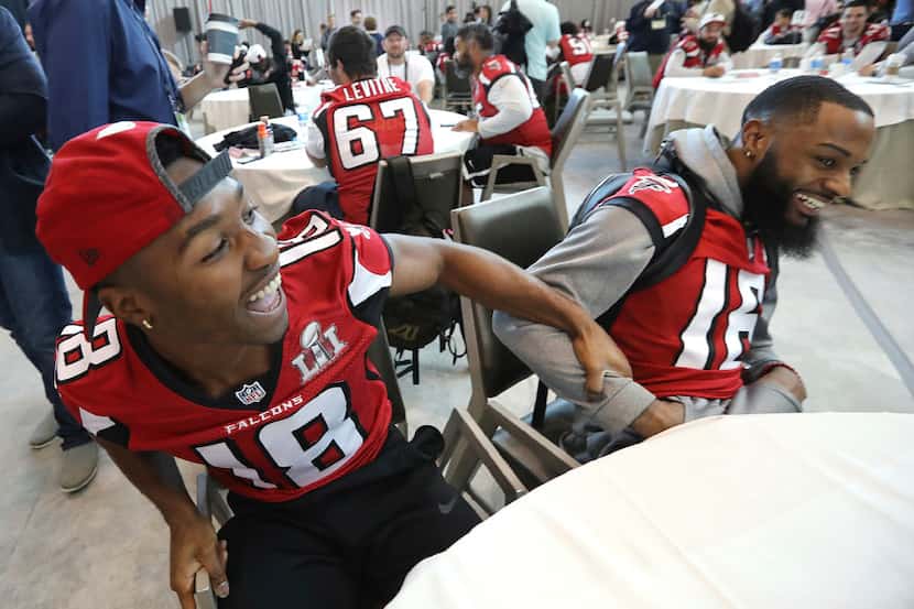 Atlanta Falcons wide receivers Taylor Gabriel, left, and Justin Hardy clown around while...