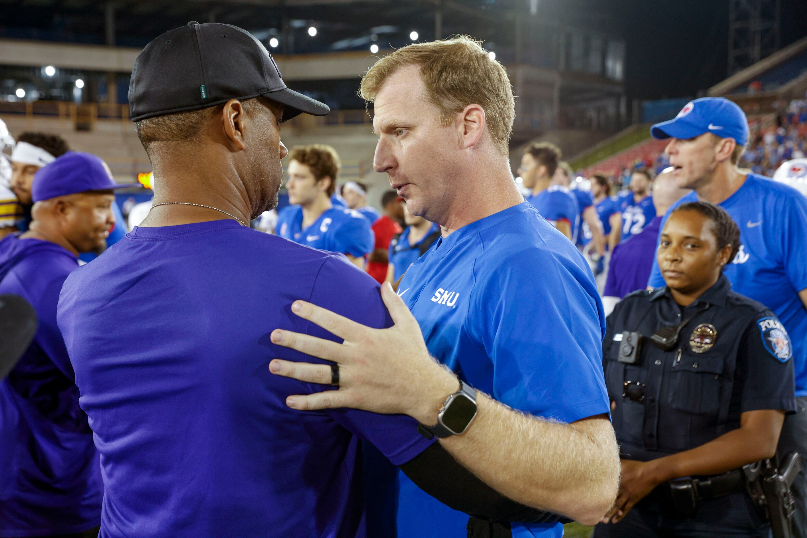 SMU head coach Rhett Lashlee (right) talks with Prairie View A&M head coach Bubba McDowell...