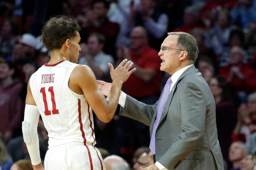 Oklahoma head coach Lon Kruger high-fives Trae Young (11) during the first half of an NCAA...