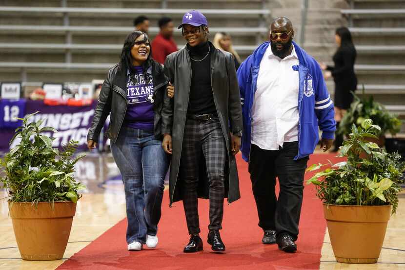 Skyline's Arabia Bradford, who signed to play football with Tarleton State, walks with his...