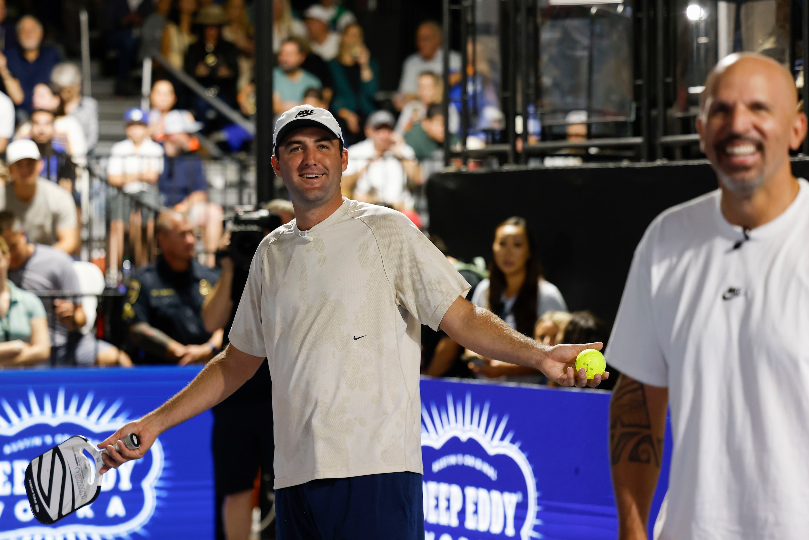 Pro golfer Scottie Scheffler (left) reacts towards crowd during Celebrity Pickleball...