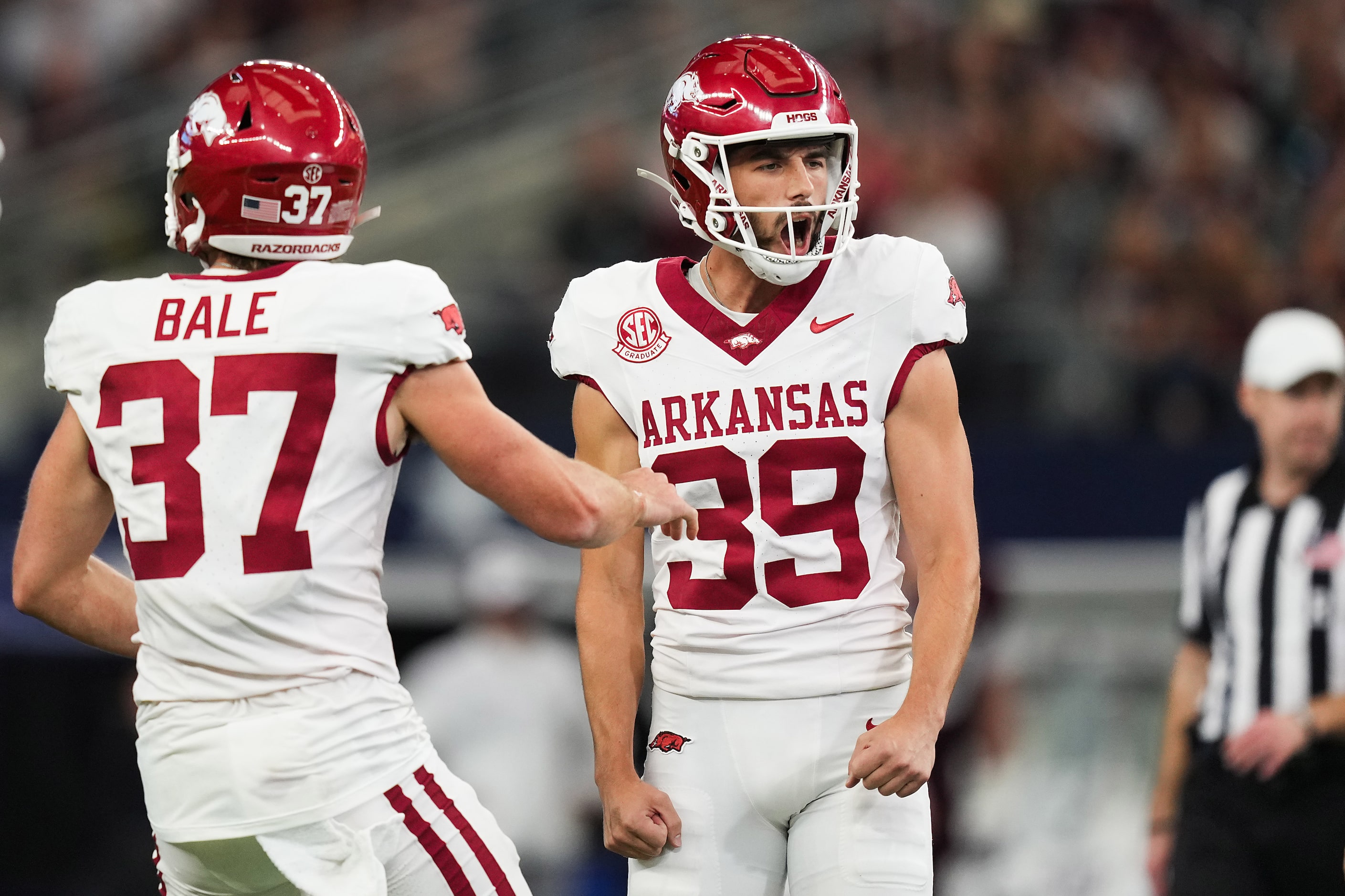 Arkansas place kicker Kyle Ramsey (39) celebrates with punter Devin Bale (37) after kicking...