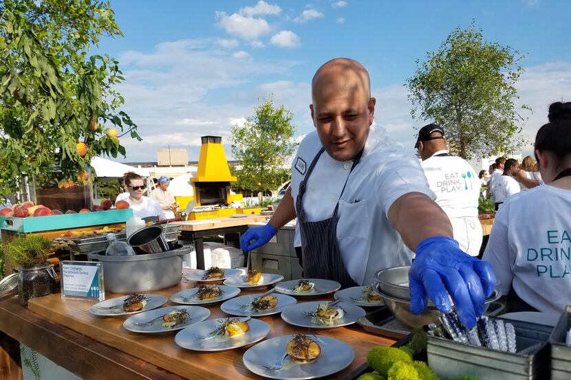 Luis Matos doled out snacks at a recent al fresco reception for Wolfgang Puck 