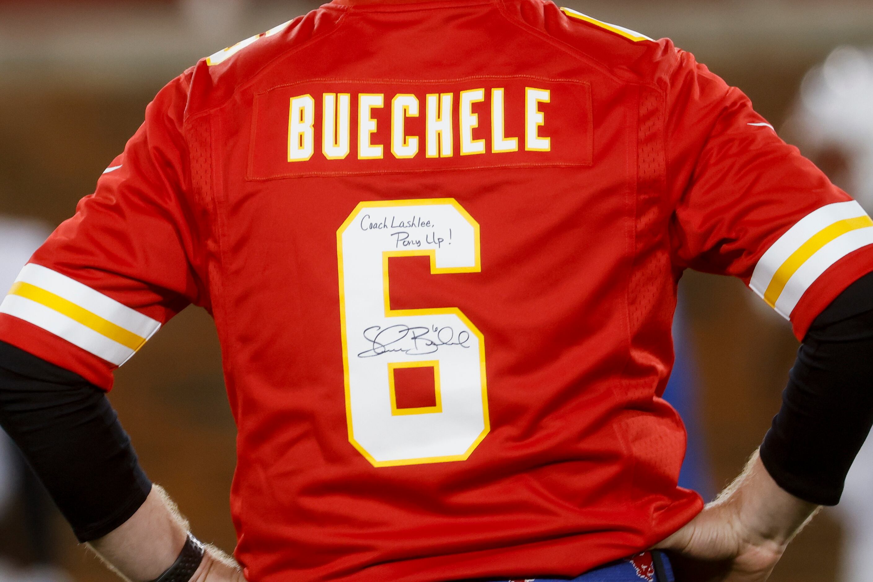 Coach Rhett Lashlee wears a Kansas City Chiefs Quarterback Shane Buechele jersey as he...