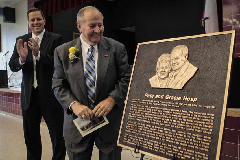 Pete Hosp reacts to the unveiling of the plaque that hangs at the Frisco elementary school...