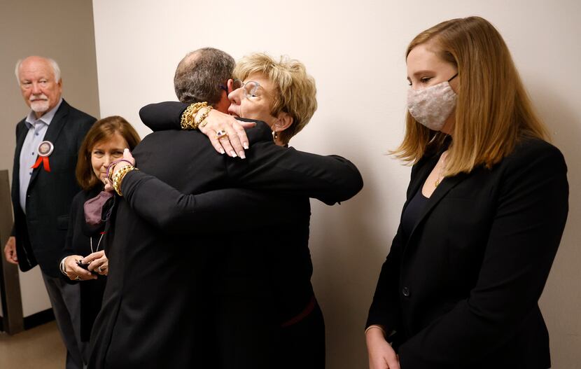 Shannon Dion (center), daughter of Doris Gleason, receives a hug as the family, including...