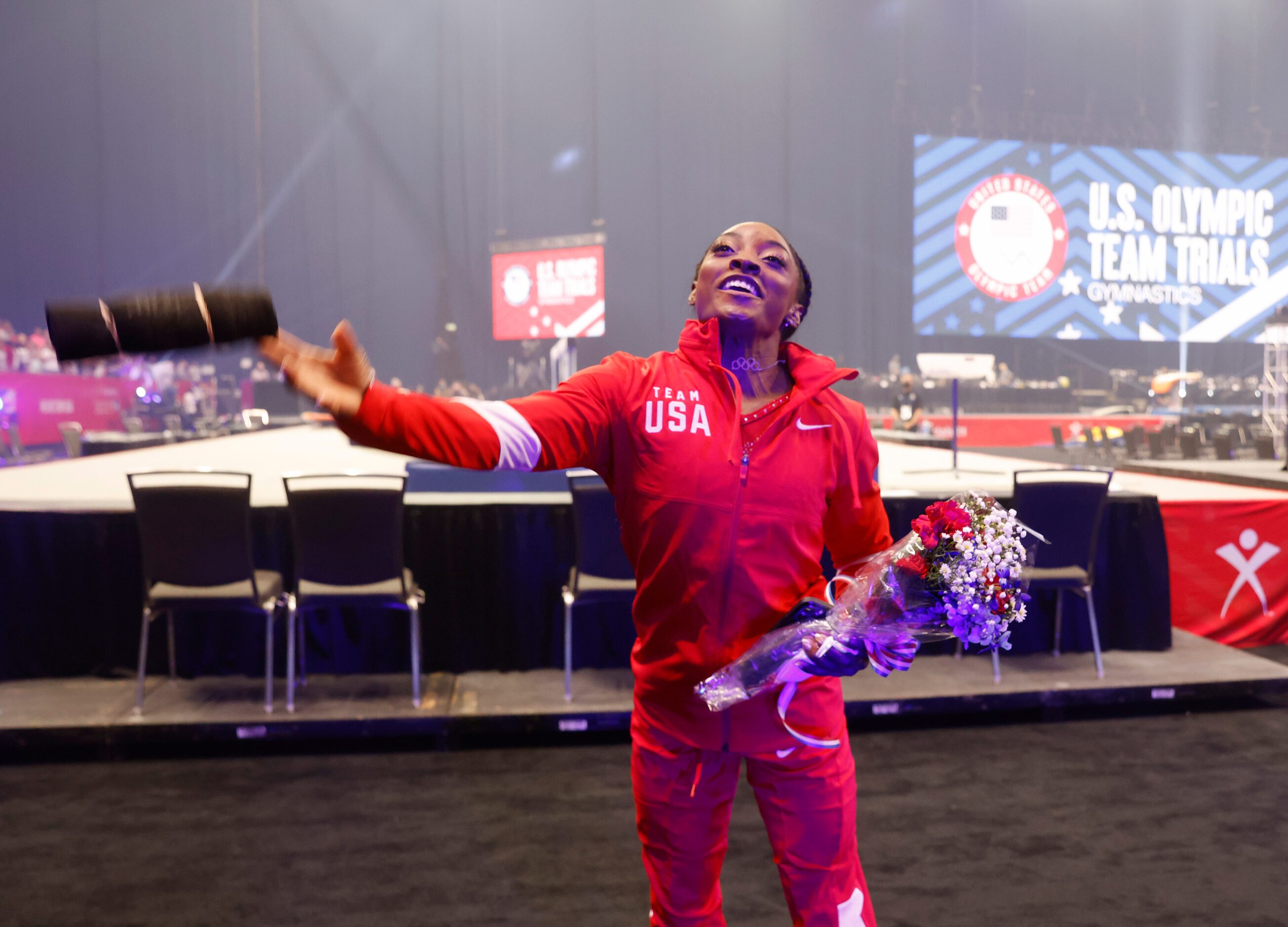 Simone Biles tosses a shirt in the stands after team introductions on day 2 of the women's...