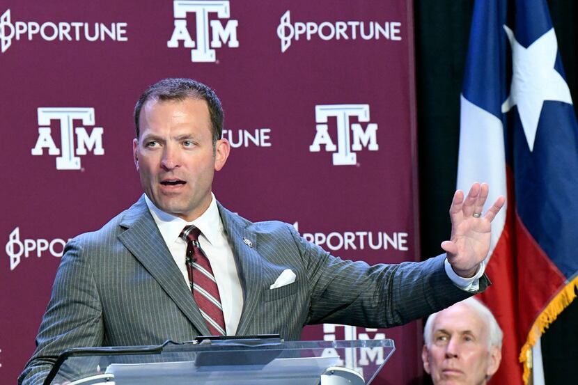 New Texas A&M athletic director Ross Bjork, left, addresses media and A&M athletic staff in...