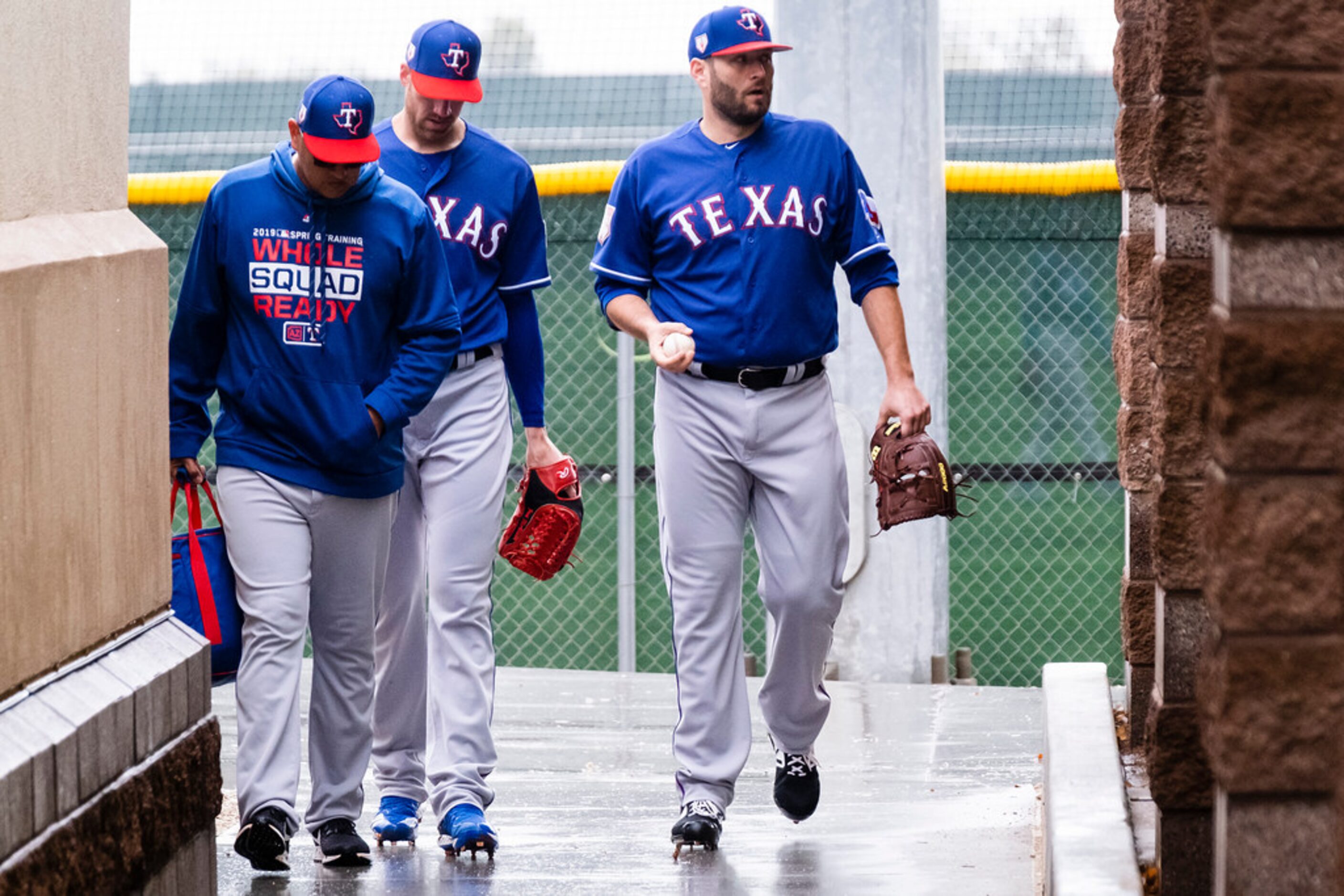 Texas Rangers pitcher Lance Lynn (right) walks toward the indoor batting cages during a...