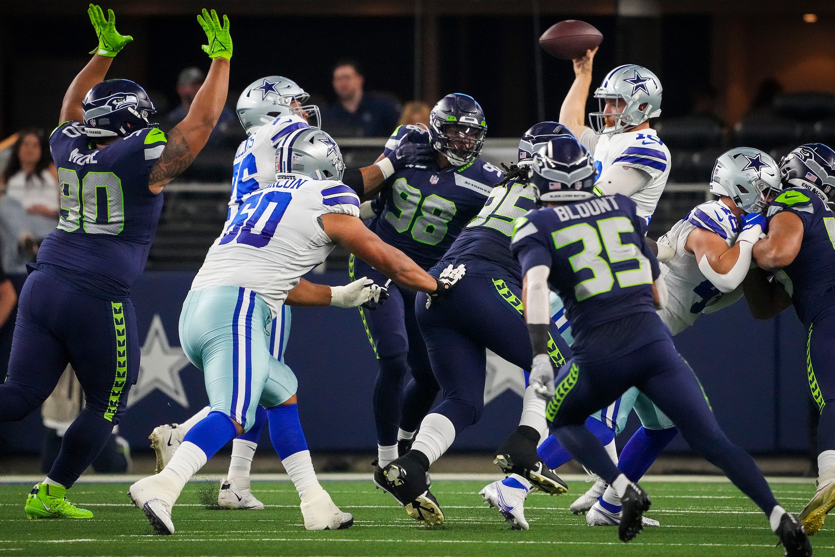 Dallas Cowboys quarterback Cooper Rush (10) gets off a pass under pressure from the Seattle...