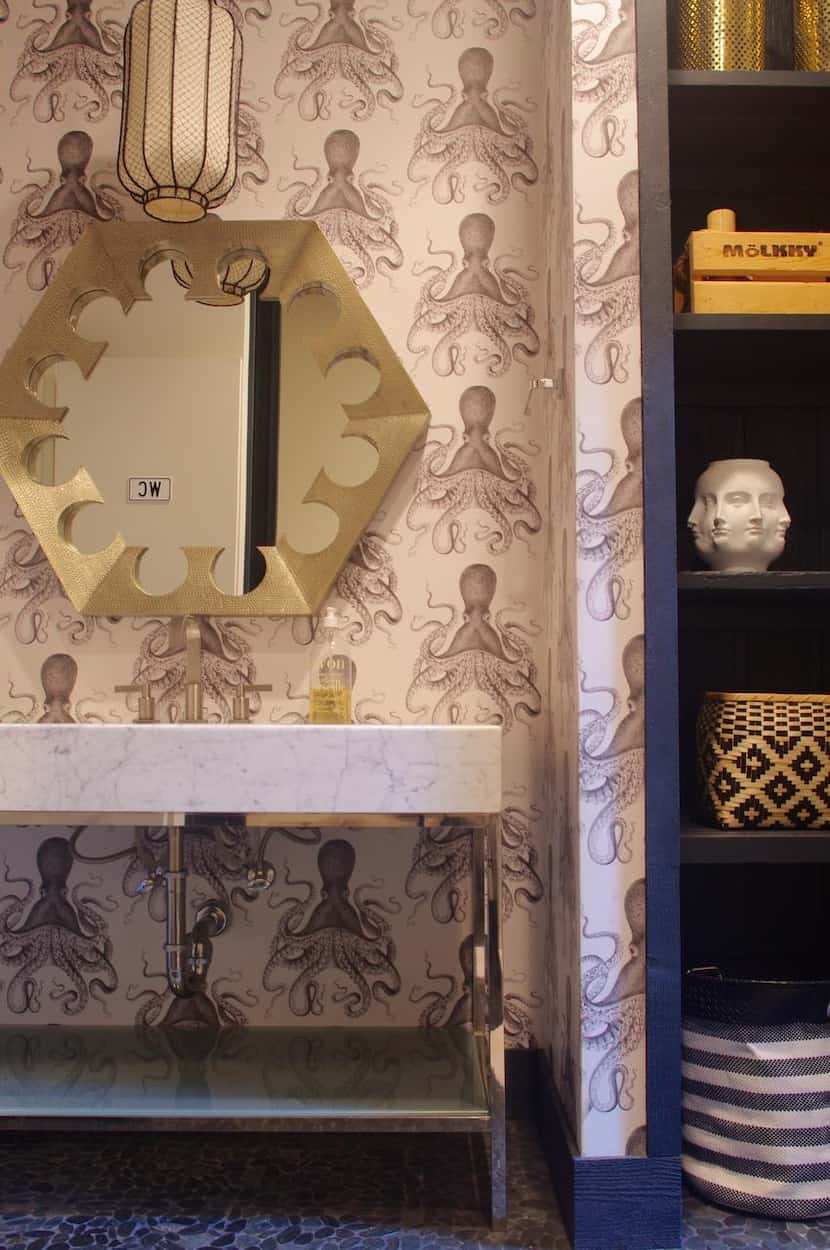 A powder bathroom that also serves a nearby pool got a dose of whimsy with octopus wallpaper...