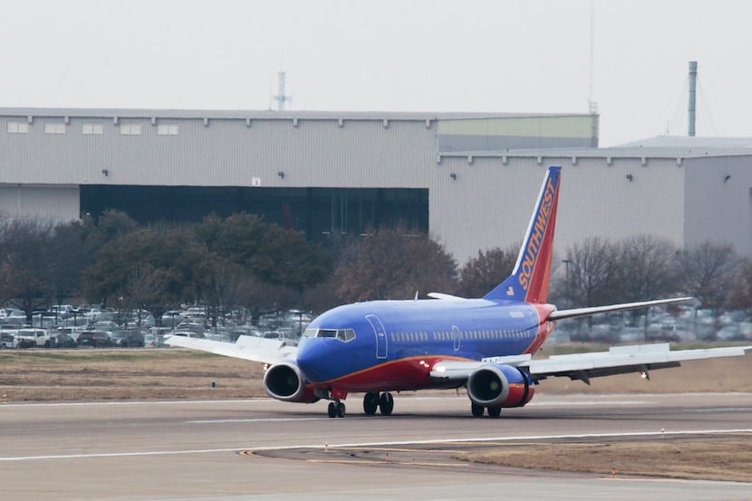  A Southwest Airlines airplane taxis after landing in front of their corporate headquarters...