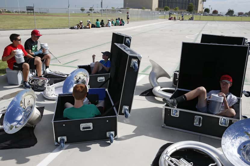 Band members get some shade in instrument boxes during marching band practice at Lebanon...
