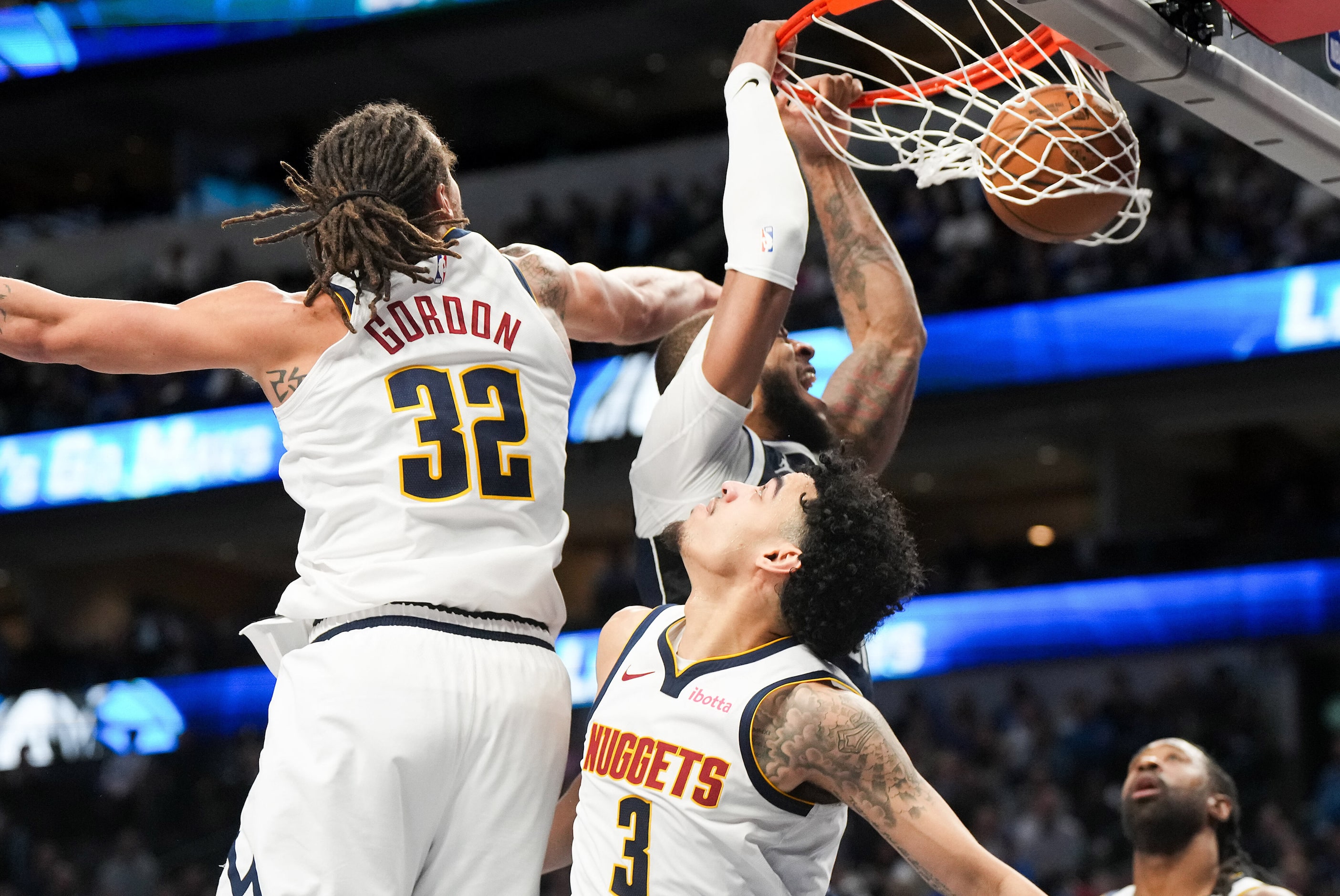 Dallas Mavericks center Daniel Gafford (21) dunks the ball past Denver Nuggets guard Julian...