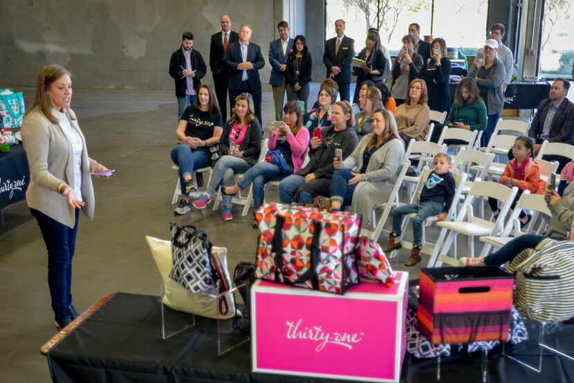 Thirty-One Gifts CEO Cindy Monroe, left, speaks to guests during an event inside the...