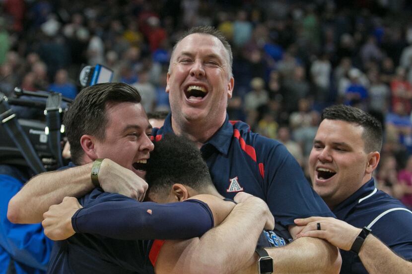 Allen coach Jeff McCullough (center) celebrates an overtime victory over Katy Tompkins in...