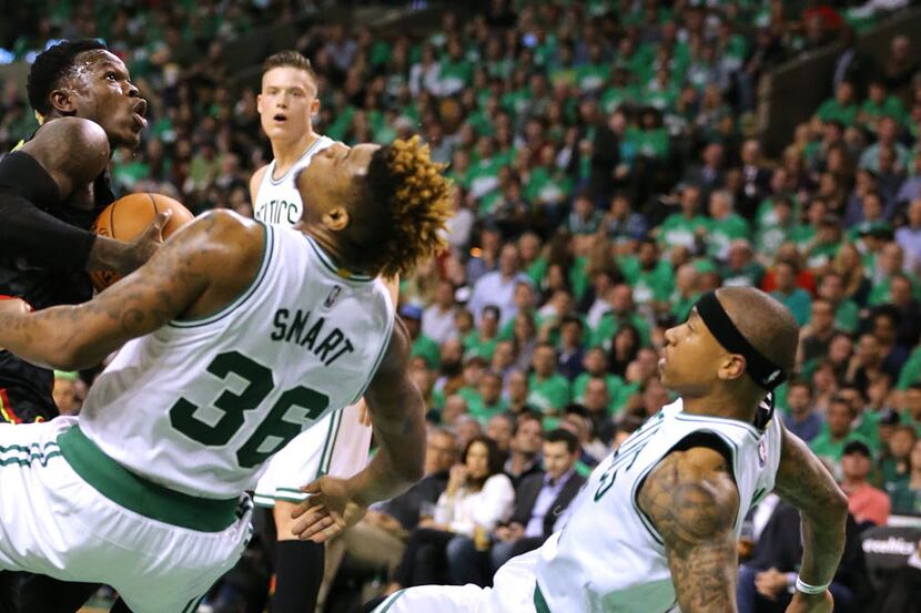 Atlanta Hawks guard Dennis Schroeder, left, knocks Boston Celtics' Marcus Smart and Isaiah...