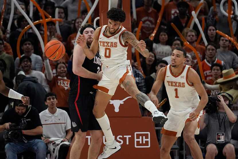 Gonzaga forward Drew Timme (2) and Texas forward Timmy Allen (0) compete for a rebound...