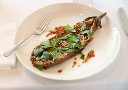 Steamed Japanese eggplant is prepared with hot garlic crisp and cilantro at Le PasSage in...