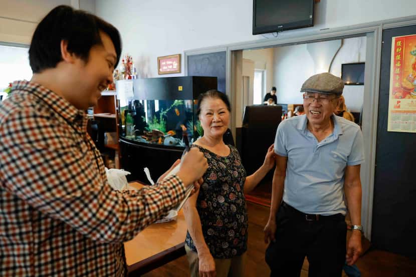 Dallas Morning News reporter Hojun Choi (left) conducts an interview for the Asian American...
