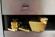 Bars of gold in a safety deposit box.
A collection of large and small gold bullion bars sit...