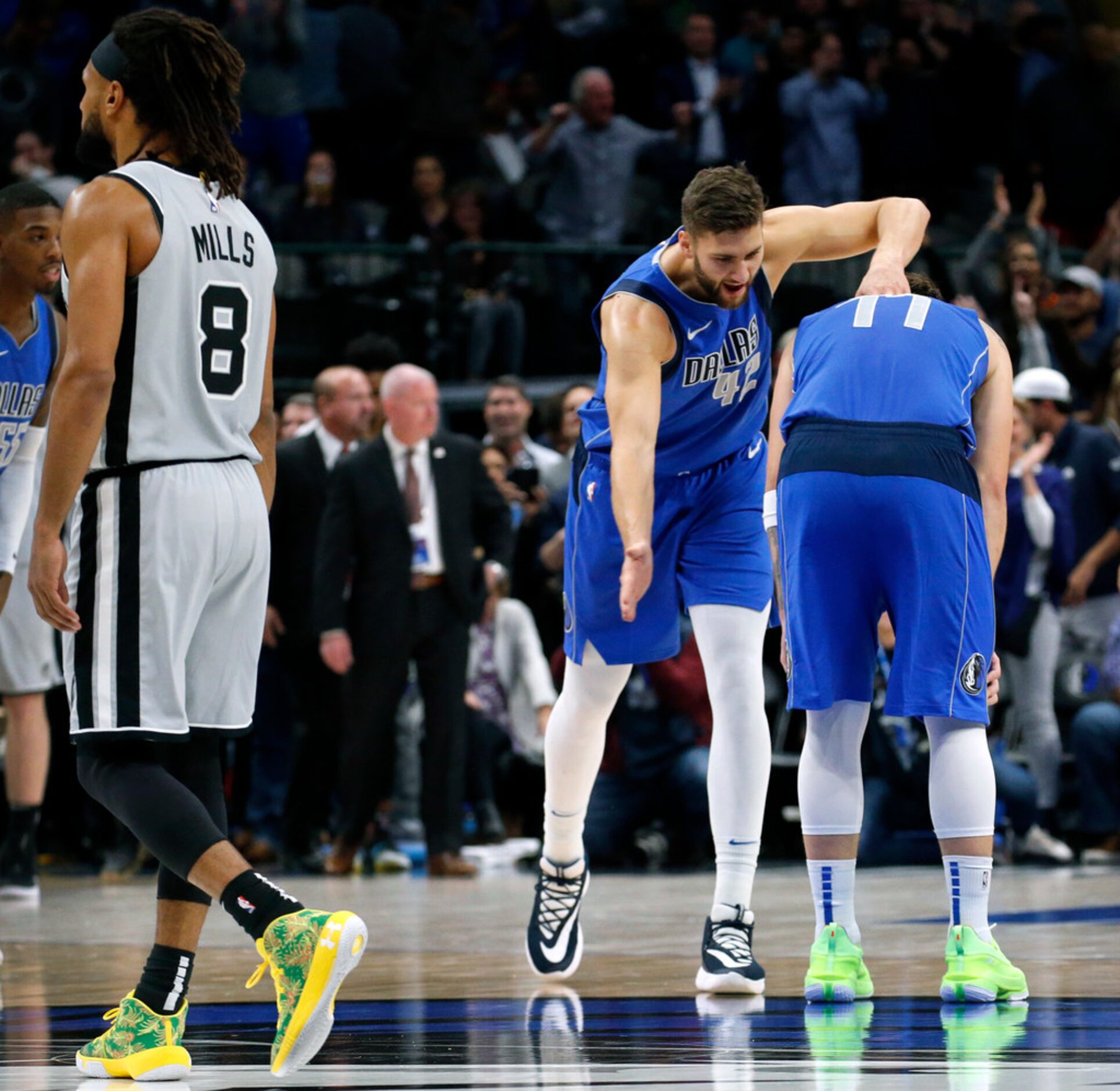 Dallas Mavericks forward Maxi Kleber (42) congratulates forward Luka Doncic (77) after being...