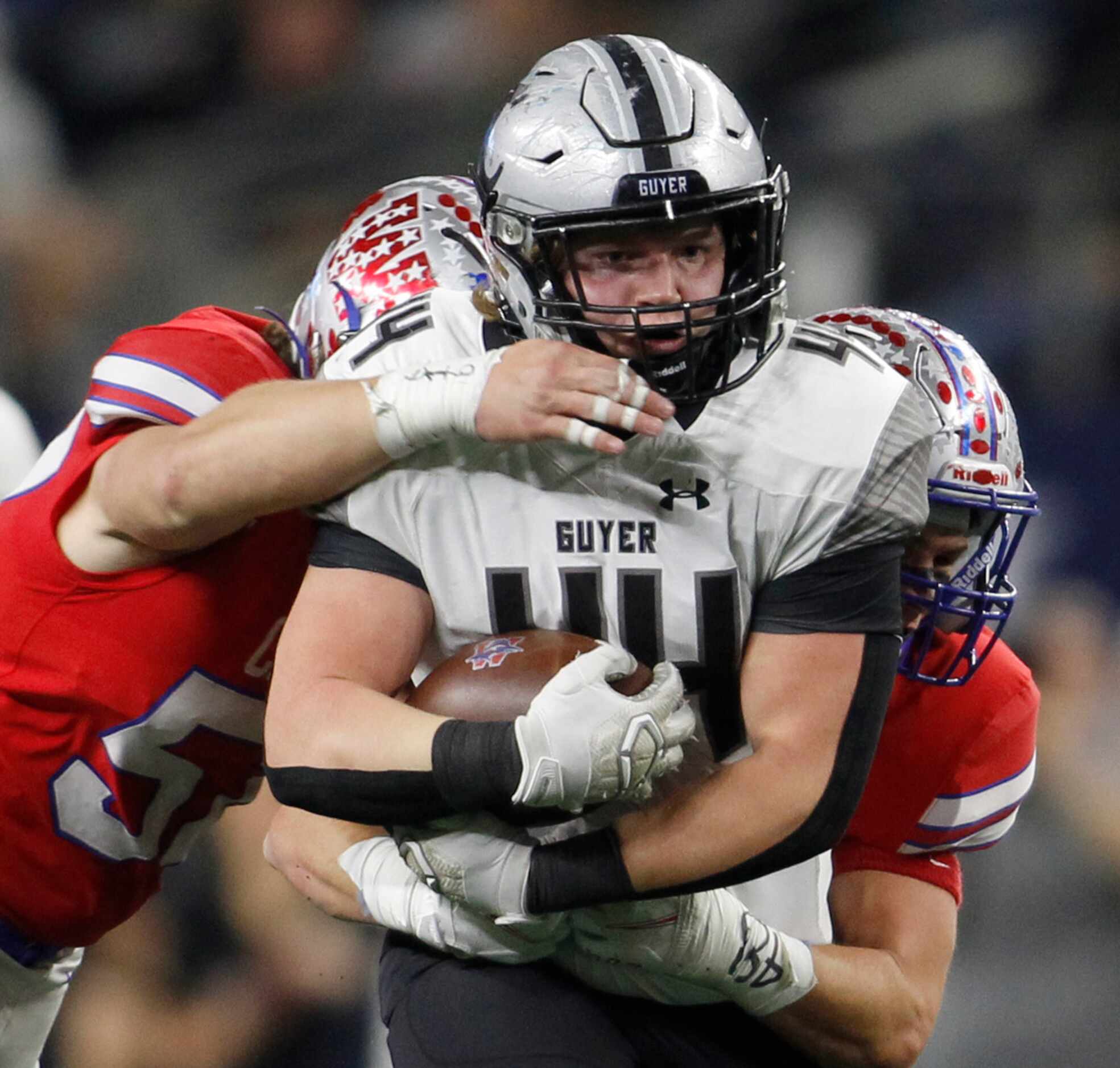Denton Guyer defensive lineman Jackson Moore (44) is brought down by a couple of Austin...