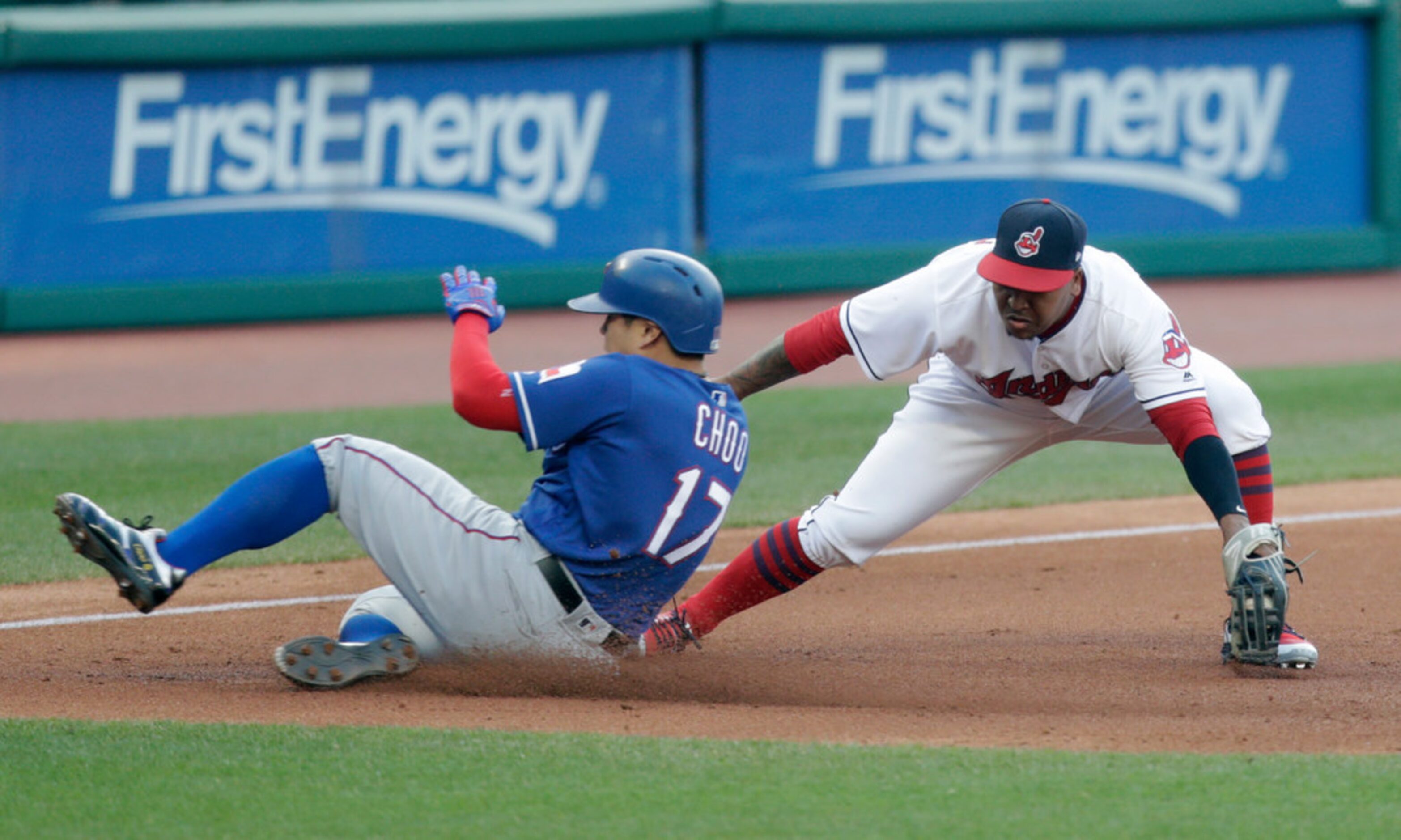 Texas Rangers' Shin-Soo Choo, left, slides safely into third base as Cleveland Indians' Jose...